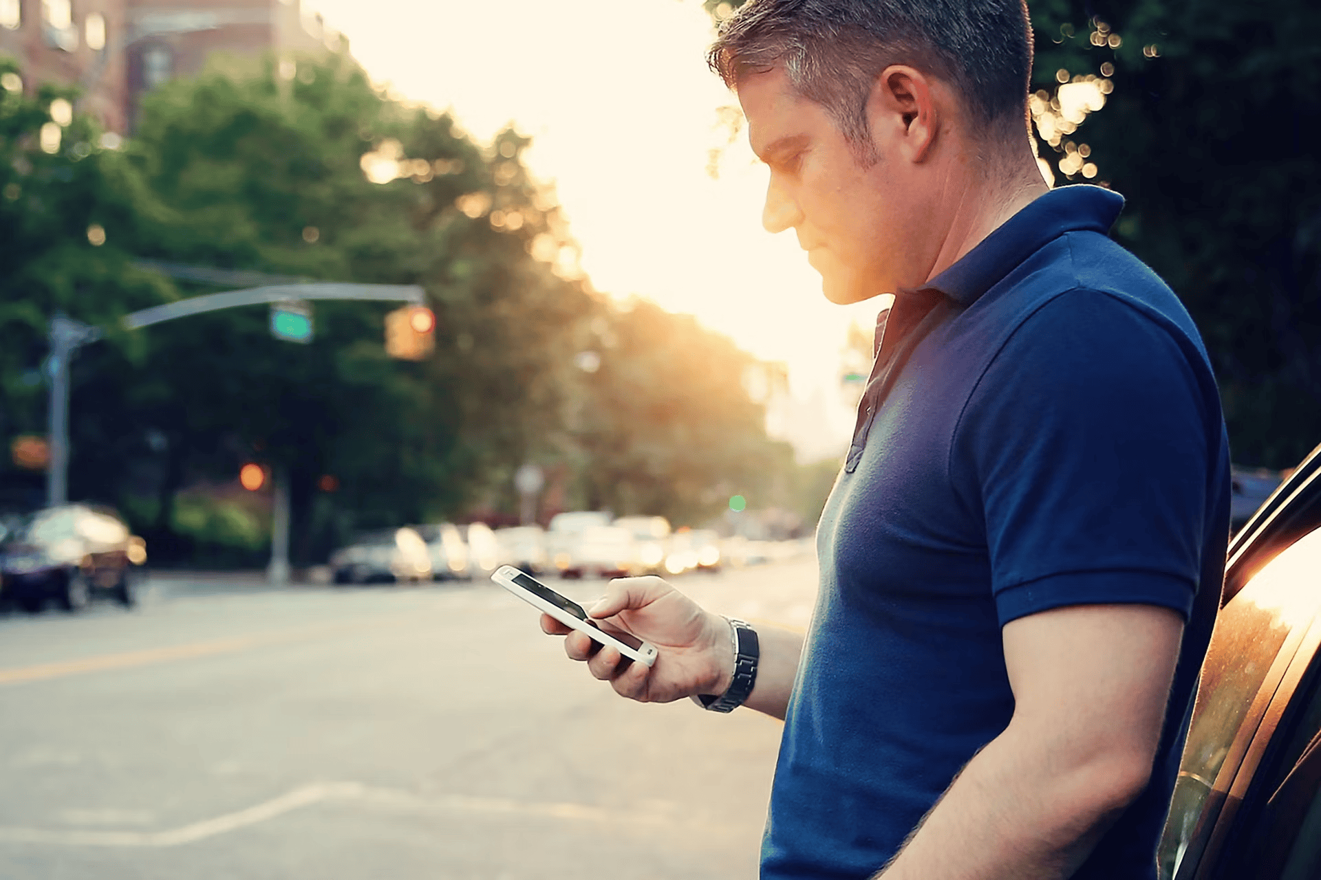 Customer checking vehicle options on smartphone at Eastgate Ford dealership.