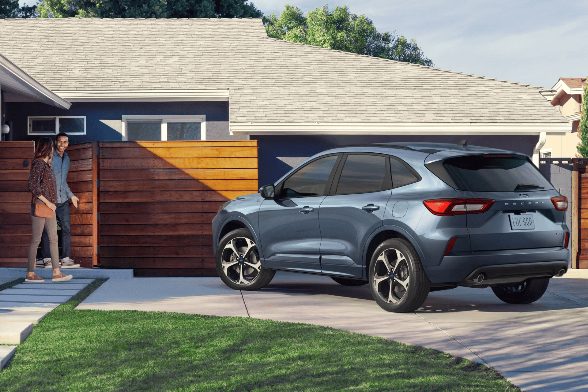 Ford SUV in front of a house in a suburban neighborhood.
